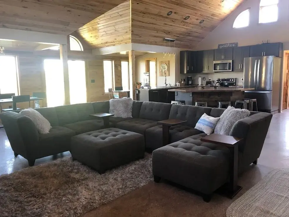 Spacious living room with modern kitchen area.