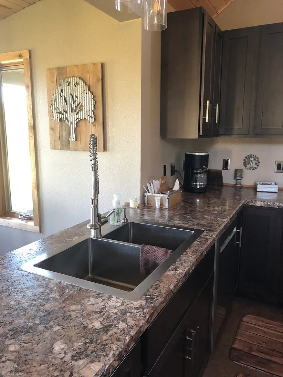 Modern kitchen with granite countertops and sink.